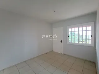 Foto de um cômodo interno com paredes brancas e piso de cerâmica.