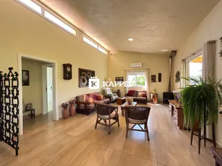 Uma sala de estar com piso de madeira e móveis de madeira escura.