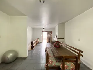 Vista do interior de uma área com piso de cerâmica e móveis de madeira.