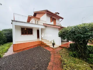 Fachada de uma casa em Lajeado, Brasil, com balcão e jardim.