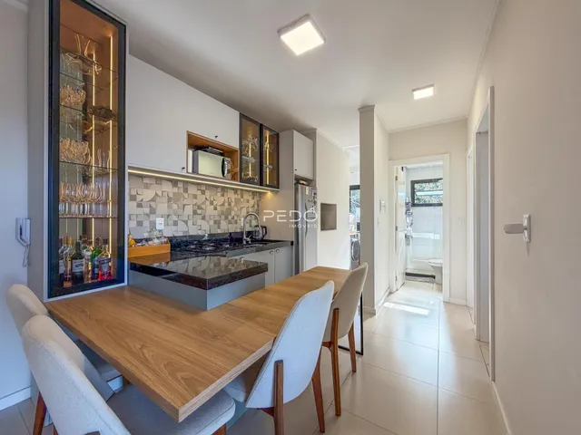 Vista de uma sala de jantar com cozinha moderna em Lajeado.