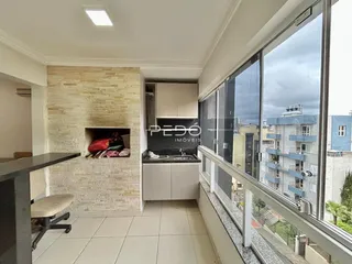 Vista da sala de estar com cozinha e varanda de um imóvel em Lajeado.