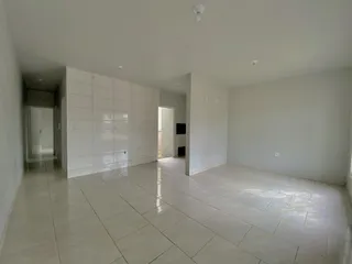 Foto de um ambiente interno com piso de cerâmica e paredes brancas.