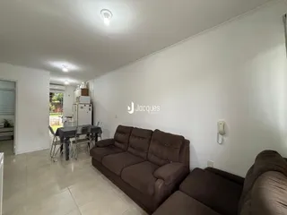 Sala de estar com sofá e mesa de jantar em um imóvel no Brasil.