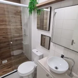 Foto de um banheiro com revestimento de azulejos brancos.