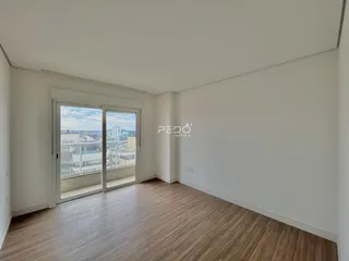 Sala de estar com vista para a cidade através de portas de vidro.