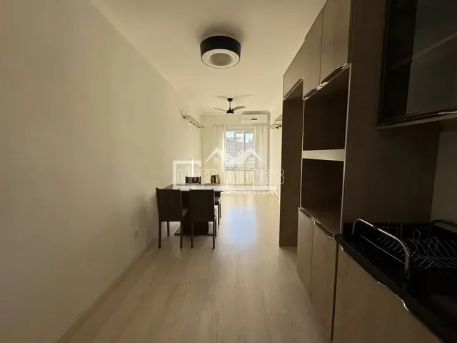Corredor com piso de madeira e armários embutidos.