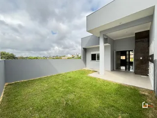 Fachada moderna de uma residência com jardim gramado.