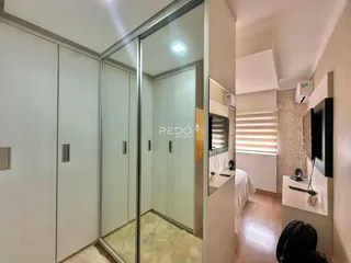 Interior de um corredor com portas de vidro espelhado em um imóvel.