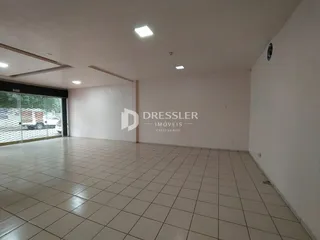 Ambiente interno de uma sala com piso de cerâmica e paredes brancas.