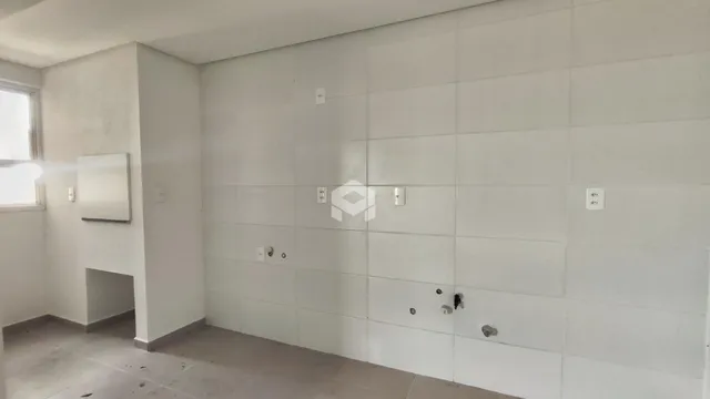 Parede interna com acabamento em concreto e piso de cimento claro.