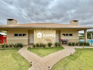 Fachada de uma casa térrea com jardim frontal e calçada de pavers.