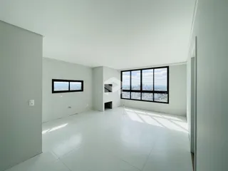 Ambiente interno amplo com grande janela de vista para a cidade.