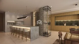 Vista de uma cozinha moderna com ilha e revestimento de pedra.