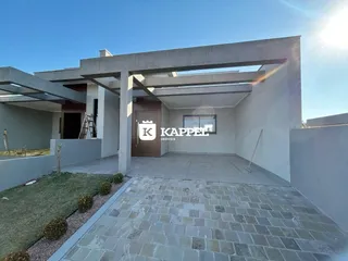Fachada de uma casa moderna em Lajeado, Brasil, com área externa pavimentada e jardim.