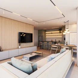 Sala de estar com sofá branco e televisão montada na parede.