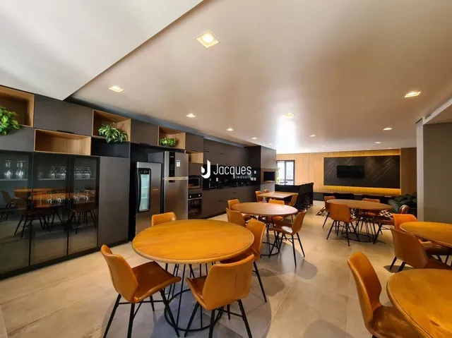Esta é uma sala de jantar com mesas de madeira.
