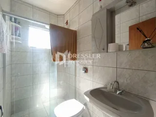 A foto mostra o interior de um banheiro com revestimento cerâmico.