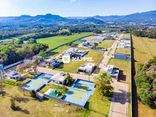 Vista aérea de um loteamento residencial com casas e uma quadra esportiva em Lajeado, Brasil.
