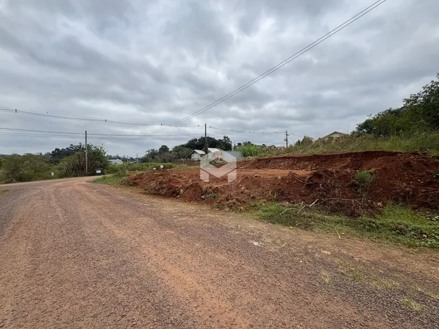 Uma estrada de terra leva a uma área de terra revolvida ao lado de uma propriedade.
