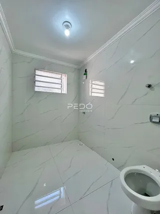 Interior de um banheiro com revestimento em mármore branco.