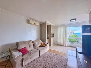 Sala de estar com sofá e vista para a janela em um imóvel no Brasil.