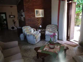 Sala de estar com parede de tijolos aparentes e móveis de estar.