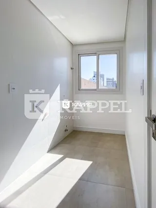 Hall de entrada interno com paredes brancas e piso claro.