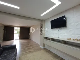 Sala de estar com piso de madeira e parede texturizada.