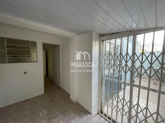 Interior de um corredor com piso de cerâmica claro.