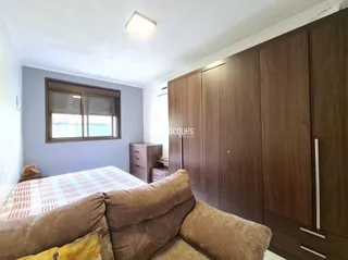 Quarto com cama e armários de madeira.