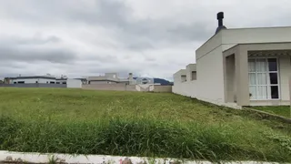 Fachada de uma casa branca com grande área gramada verde.