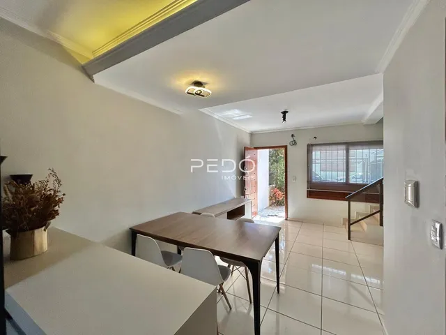 Ambiente interno de sala com mesa de jantar e piso de cerâmica.