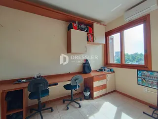 Ambiente interno com painéis de madeira e uma janela grande.