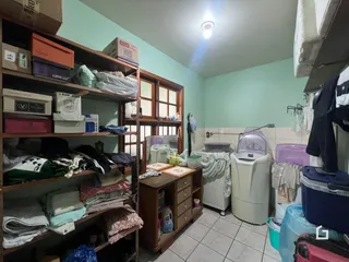 Foto de uma área de serviço com roupas e máquinas de lavar.