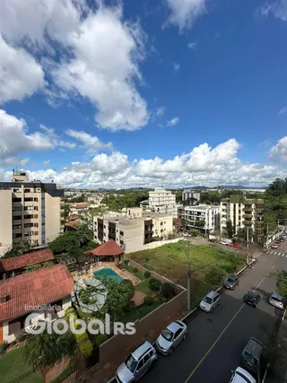 Vista aérea de uma área residencial com edifícios e vegetação em Lajeado.
