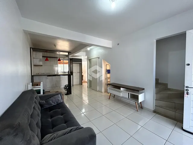 Sala de estar de um imóvel em Lajeado, Brasil com piso cerâmico.