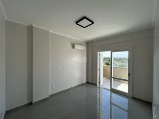 Interior de uma sala com piso de porcelanato e janela de vidro.