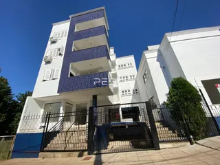 Fachada de um prédio residencial em Lajeado, Brasil com varandas e grade de segurança.