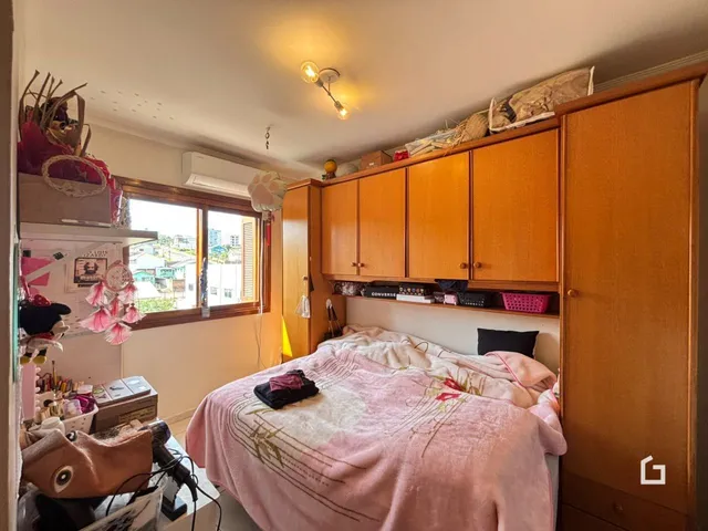Um quarto com cama e armários de madeira em um imóvel no Brasil.