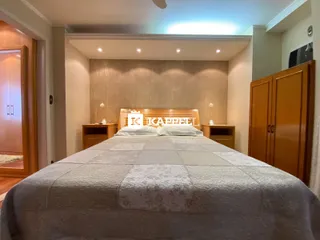 Quarto com cama grande e armário de madeira.