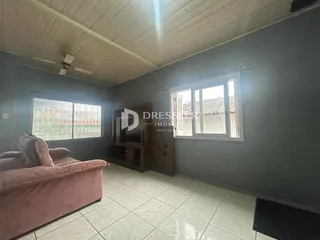 Sala de estar com sofá e janela em um imóvel no Brasil.