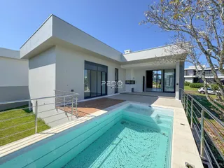 Fachada de uma residência moderna com piscina e deck no Brasil.