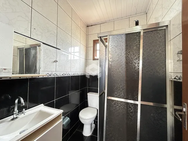 Foto de um banheiro com revestimento de azulejos brancos e pretos.