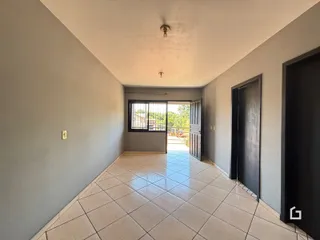 Corredor com piso de cerâmica que leva a uma porta externa.