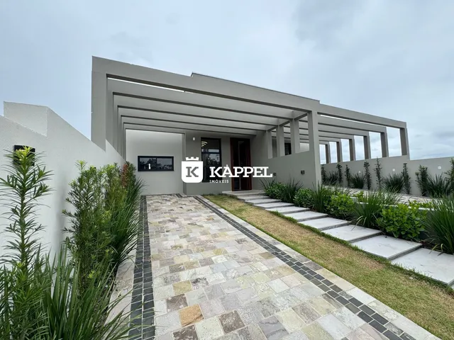 Fachada moderna de uma residência com paisagismo frontal em Lajeado.