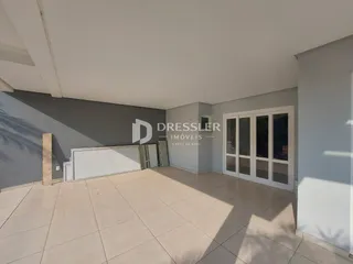 Interior de uma sala com piso de cerâmica e portas de vidro.