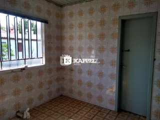 Foto interna de um cômodo com papel de parede estampado e piso de cerâmica.