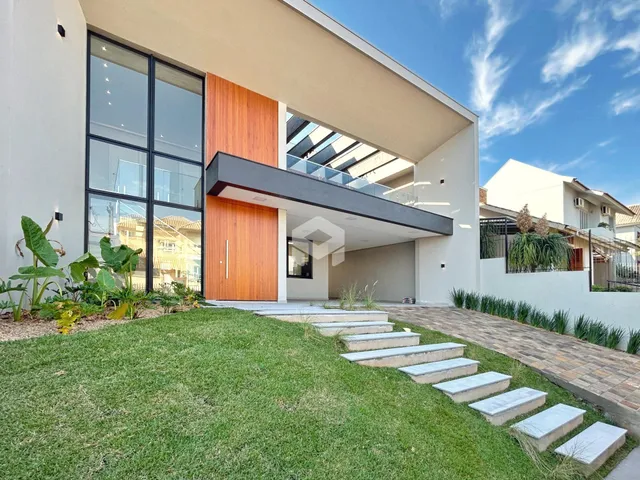 Fachada moderna de uma residência com jardim e terraço em Lajeado.