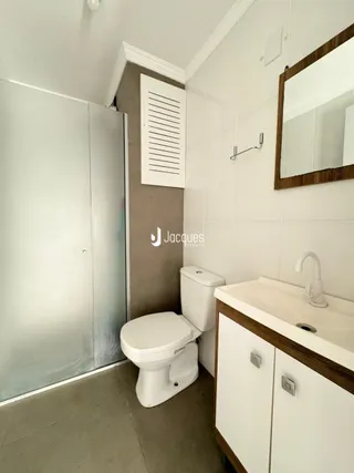 Foto de um banheiro interno com revestimento branco.